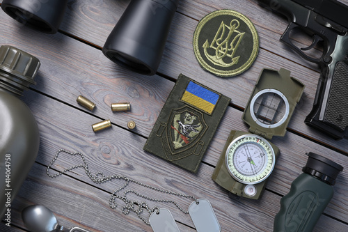 MYKOLAIV, UKRAINE - SEPTEMBER 19, 2020: Flat lay composition with Ukraine military equipment on grey wooden table