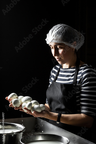 Принти на полотні A woman working in a small family creamery is processing the final steps of making a cheese