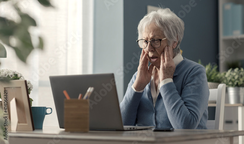 Senior woman struggling with technology photo