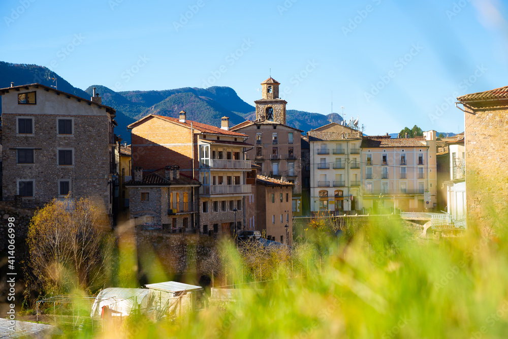 street with river and residential buildings in La Pobla de Lillet in Spain