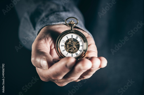 Man holding pocket watch concept for time