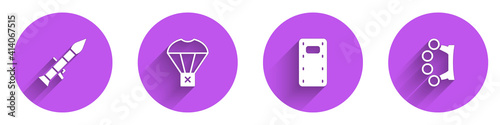Set Rocket launcher, Box flying on parachute, Military assault shield and Brass knuckles icon with long shadow. Vector.
