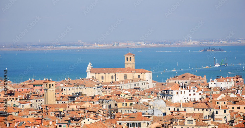 Venetian roof cityscape and lagoon at background. Venice, Italy.