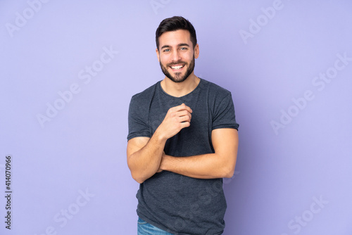 Caucasian handsome man laughing over isolated purple background photo