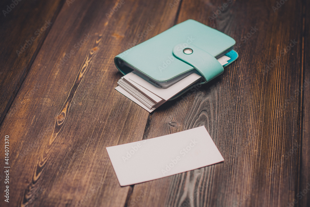 classic business card holder with clasp and white paper wooden table classic business card holder with clasp and white paper wooden table