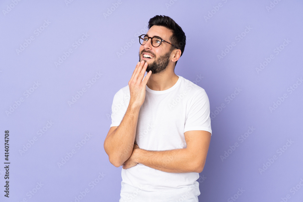 Caucasian handsome man over isolated background looking up while smiling Caucasian handsome man over isolated background looking up while smiling