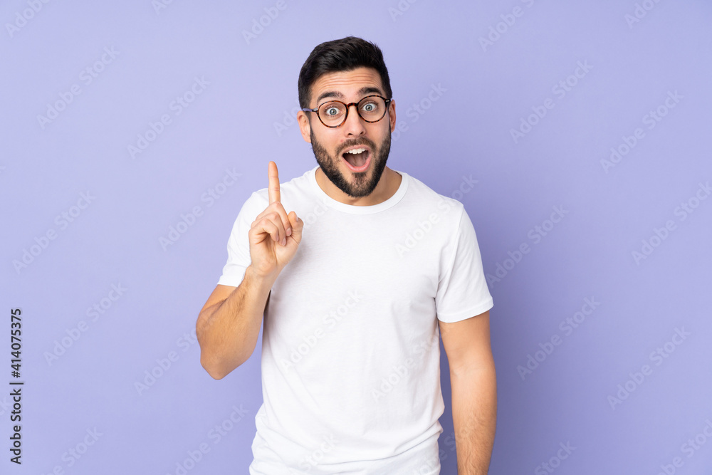 Caucasian handsome man over isolated background intending to realizes the solution while lifting a finger up Caucasian handsome man over isolated background intending to realizes the solution while lifting a finger up