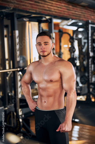 Handsome young bodybuilder spending day in gym