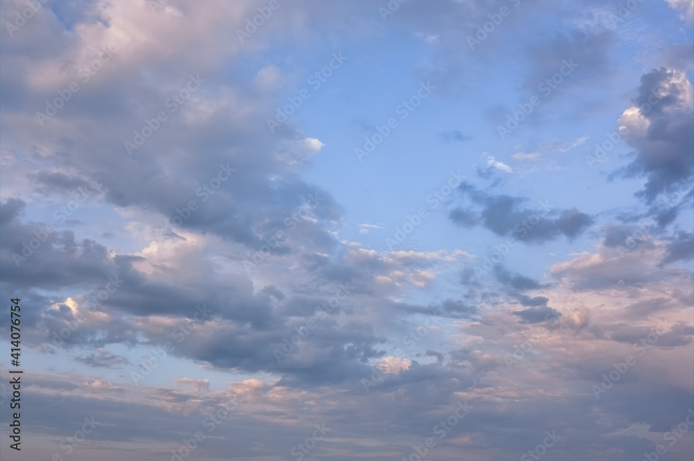 The sky at sunset. Cumulus clouds lit by the rays of the setting sun. The sky at sunset. Cumulus clouds lit by the rays of the setting sun.