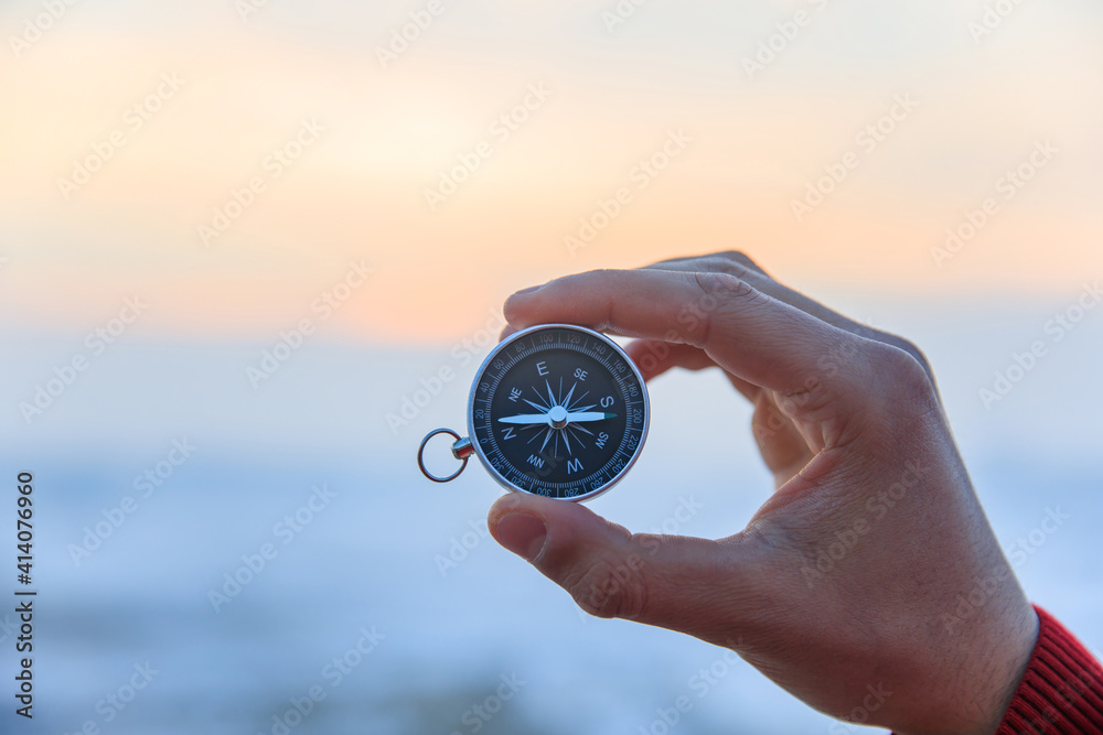 man holding compass