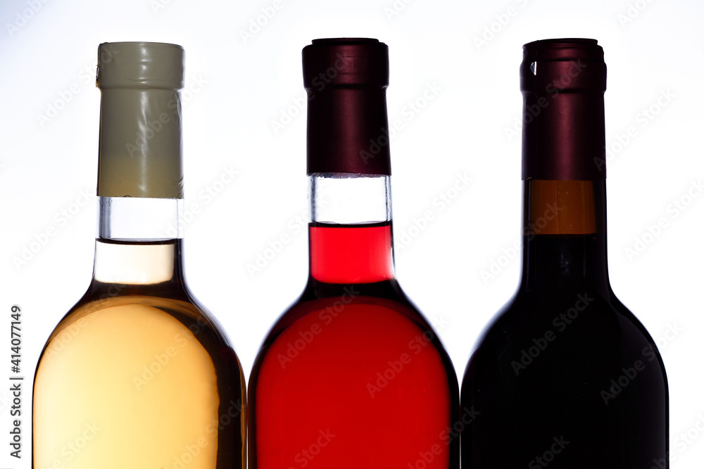 Set Of White, Rose, And Red Wine Bottles. Three bottles with red, pink and white wines isolated on white. Set Of White, Rose, And Red Wine Bottles. Three bottles with red, pink and white wines isolated on white.