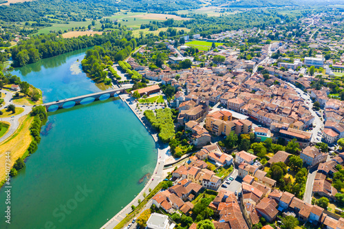 View from drone of cityscape of small French town of Cazeres on river Garonne in summer photo