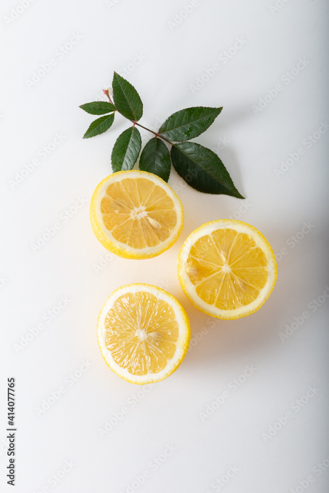Lemon slices with green leaf on white background. Top view. Lemon slices with green leaf on white background. Top view.