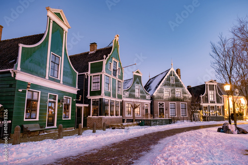 snow covered windmill village in the Zaanse Schans Netherlands, historical wooden windmills in winter Zaanse Schans Holland during winter photo