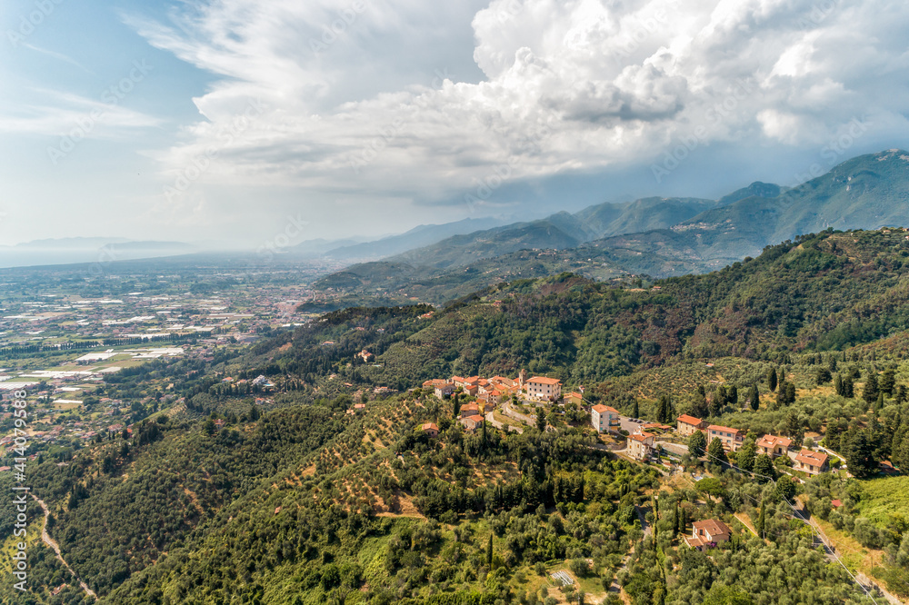 Obraz premium Aerial view of the Tuscan village Mommio Castello, at the top of the hill of Versilia, province of Lucca, Italy
