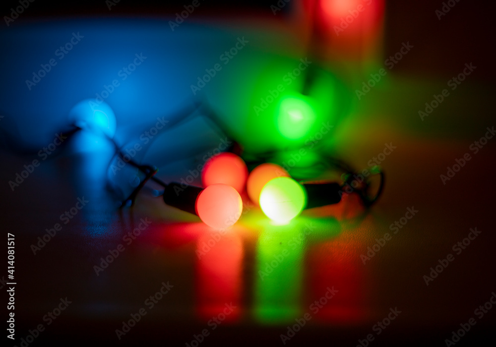multicolored glowing lanterns on a dark blurred background, romance