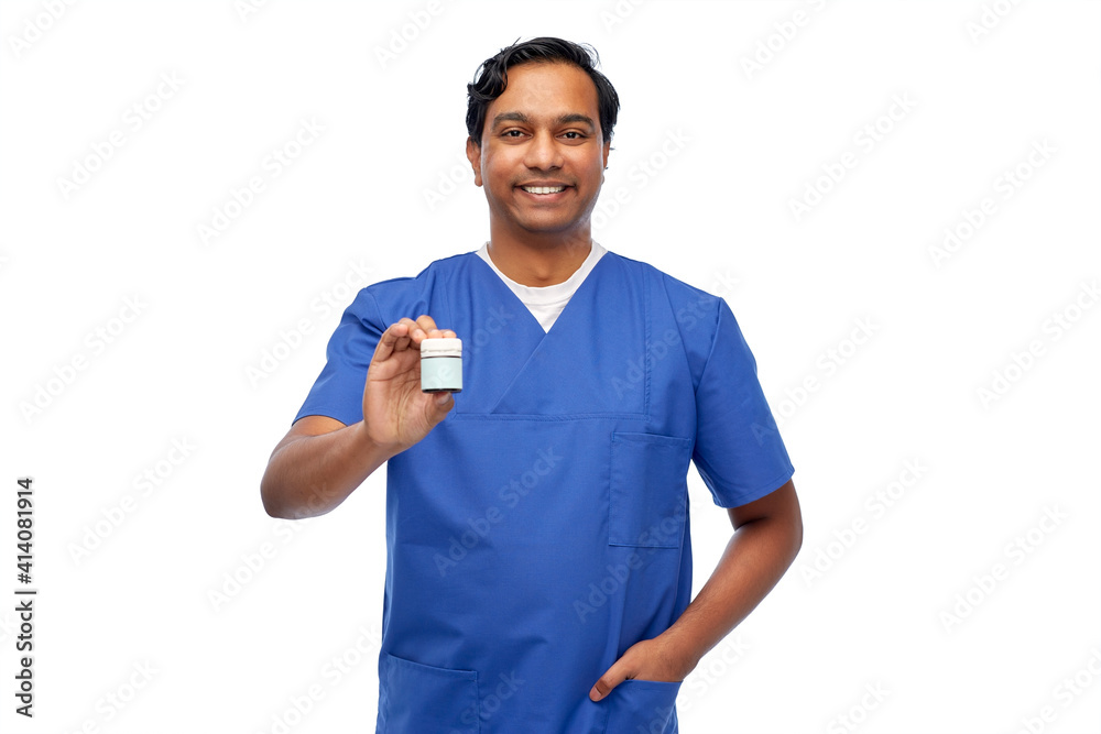 medicine, profession and healthcare concept - happy smiling indian doctor or male nurse holding jar of pills over white background medicine, profession and healthcare concept - happy smiling indian doctor or male nurse holding jar of pills over white background