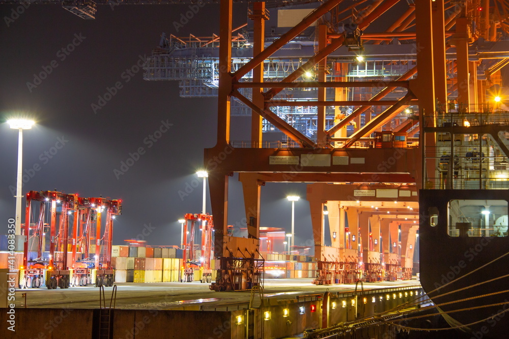 Pier of container harbour port during loading process with cranes ...