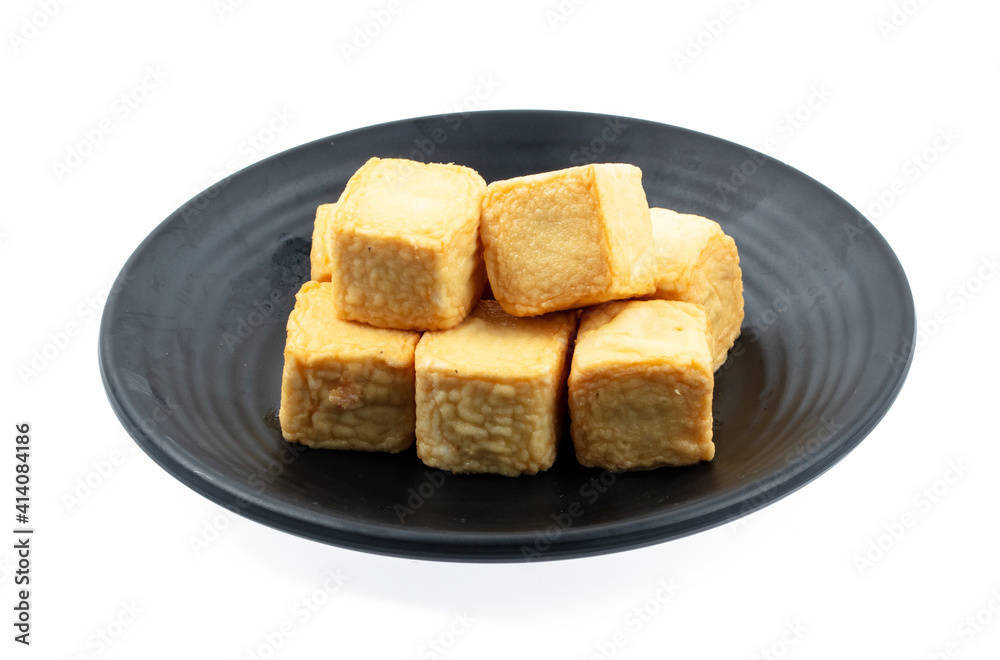 fresh raw tofu sliced on square plate isolated on white background, shabu, hot pot ingredients