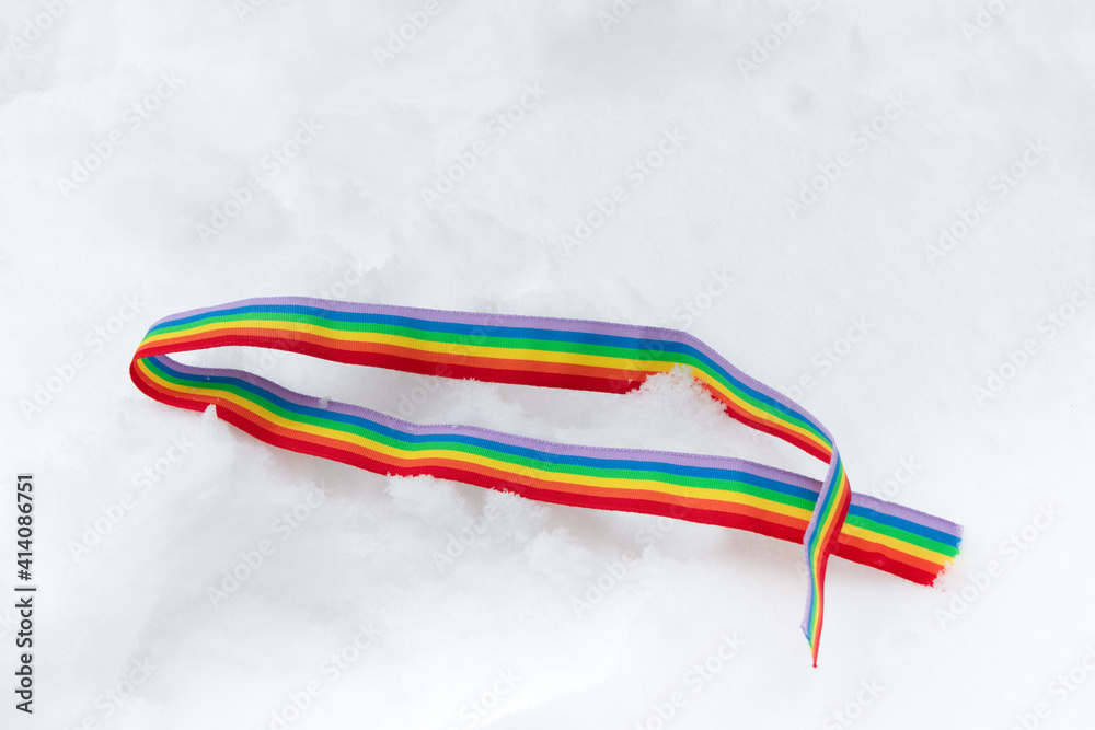 A ribbon with a rainbow of white snow