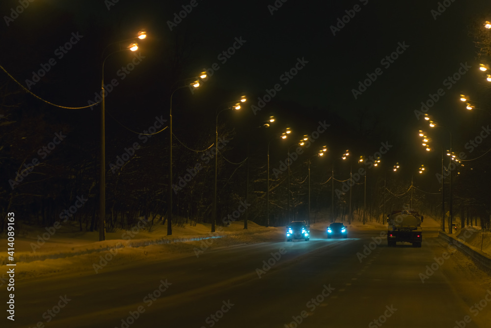 Cars in traffic in winter in the evening dark