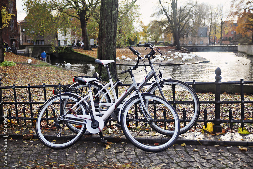 Two white, retro bicycles at Brugge