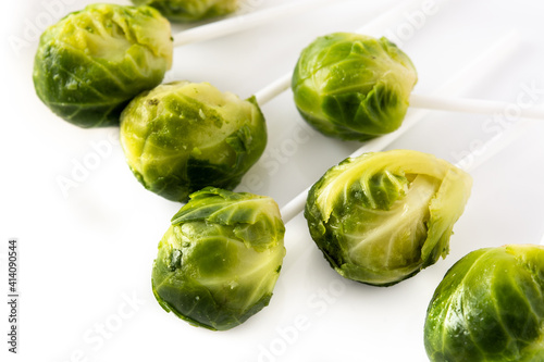 Set of brussel sprouts with lollipop sticks on white background