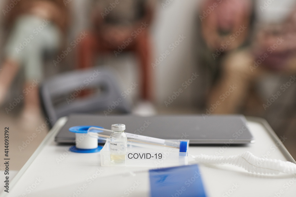 Background image of covid vaccine set and coronavirus test on desk in clinic, copy space