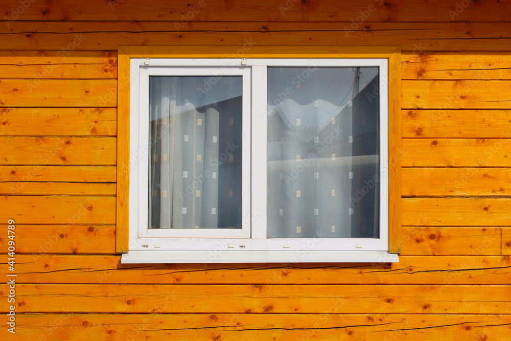 Fototapeta premium White glass plastic window in a wooden house. Double-glazed window. Close-up. Background. Texture.