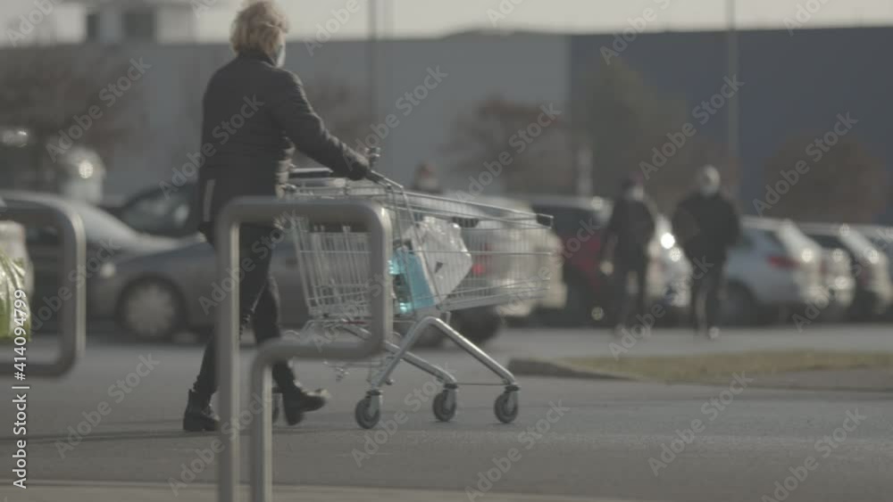 People push shopping cart in front of the store.
