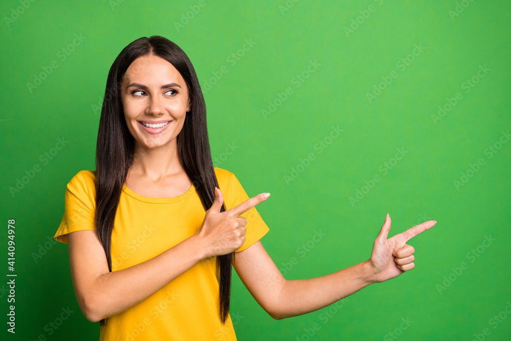 Photo of young girl happy smile dream dreamy look point fingers empty space ad promo choice choose isolated over green color background Photo of young girl happy smile dream dreamy look point fingers empty space ad promo choice choose isolated over green color background