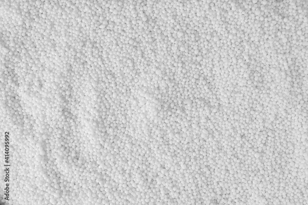 Obraz premium Pellets of ammonium nitrate as background, top view. Mineral fertilizer