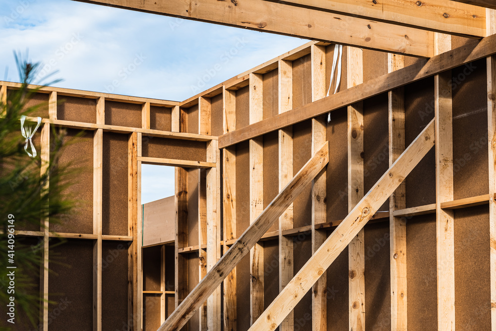 Wood planks s for walls and beams in the construction of a new sustainable wooden house. Wood planks s for walls and beams in the construction of a new sustainable wooden house.