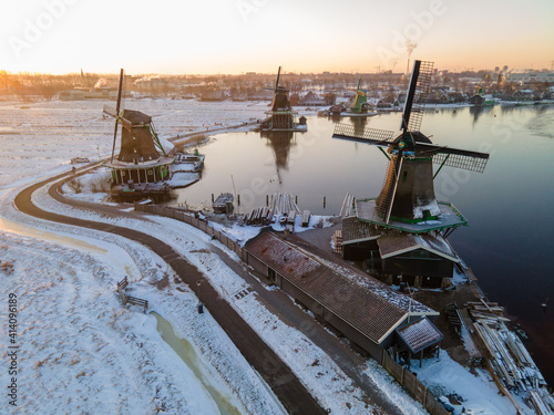 snow covered windmill village in the Zaanse Schans Netherlands, historical wooden windmills in winter Zaanse Schans Holland during winter photo