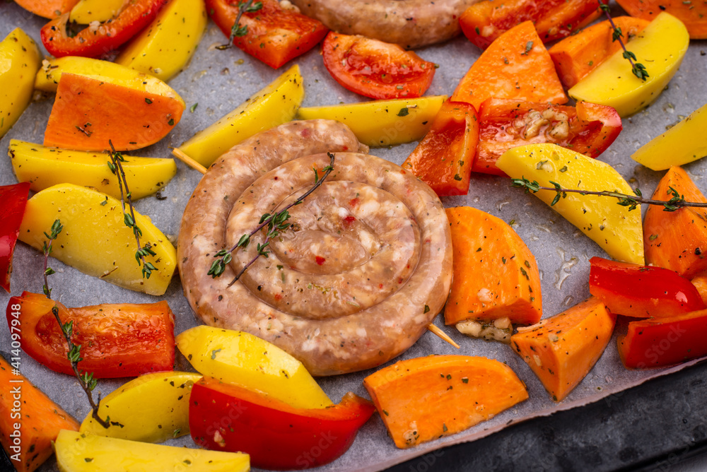 Uncooked chicken sausages with vegetables Uncooked chicken sausages with vegetables