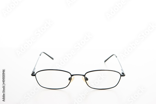 Simple used black metal wire glasses frame and lens close up studio shot isolated on white