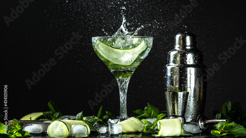 Gin-tonic alcoholic cocktail. liquor, ice. Freeze motion, drops in liquid splash