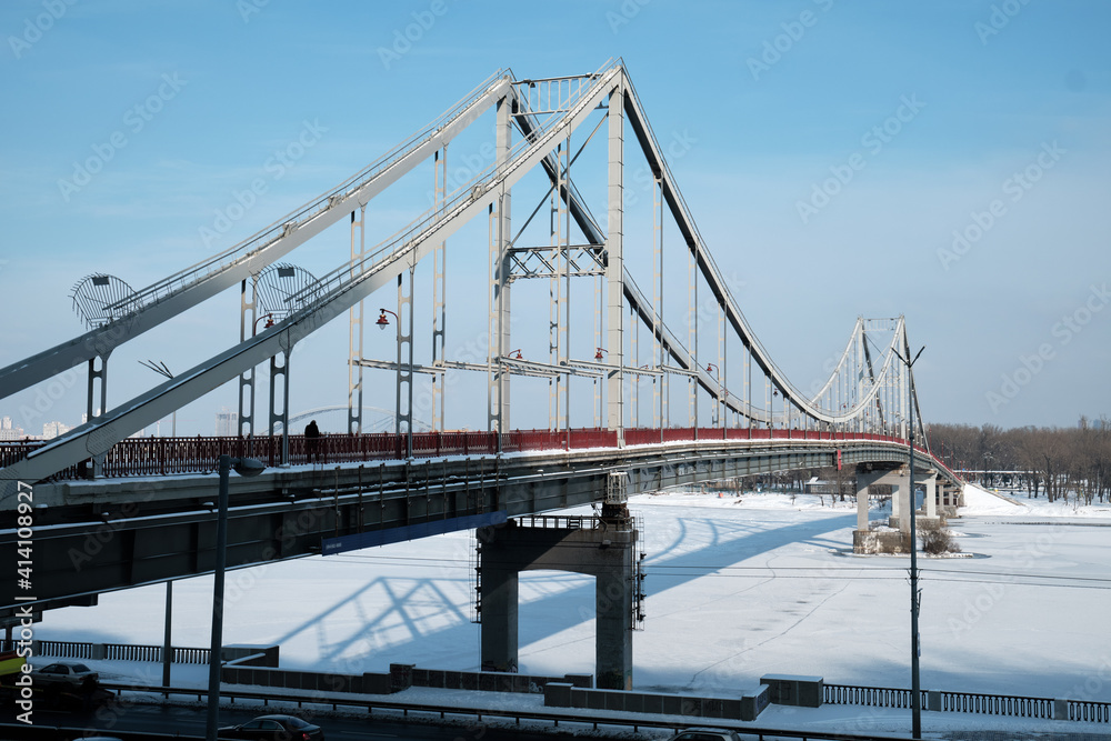 Fototapeta premium Pedestrian bridge in winter in Kyiv.
