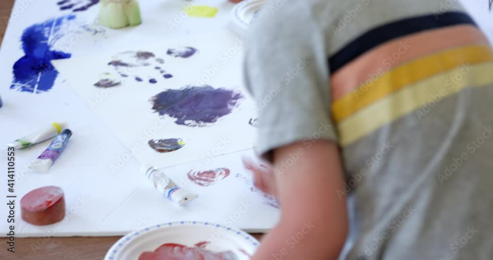 Boy finger painting at home - from behind Boy finger painting at home - from behind