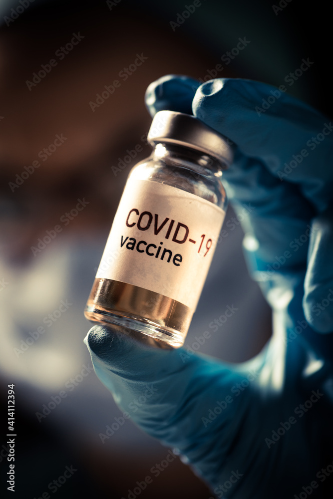 Female doctor holding a COVID-19 vaccine