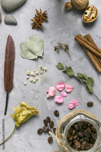 Fototapeta Naklejka Na Ścianę i Meble -  Spices, coffee and dried flowers on a gray table: witch's supplies 