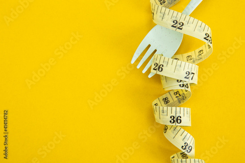 Proper nutrition for slimming. Fork with wound measuring tape.