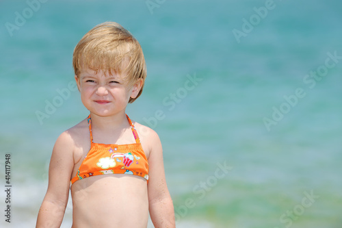 Beautiful little girl playing in the sea