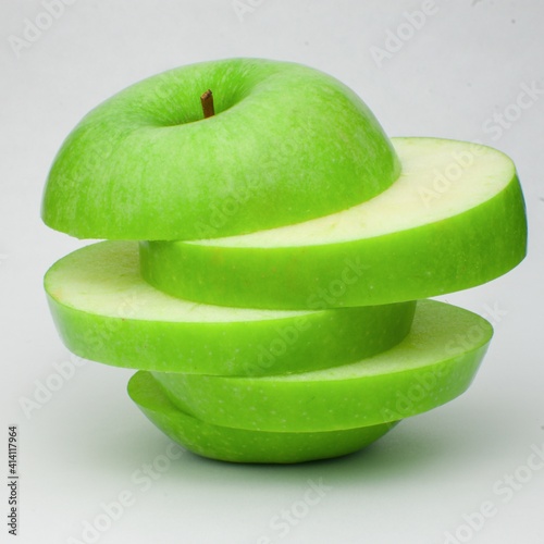 Sliced green apple on white background