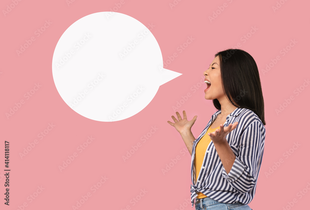 Emotional asian woman screaming at white speech bubble Emotional asian woman screaming at white speech bubble