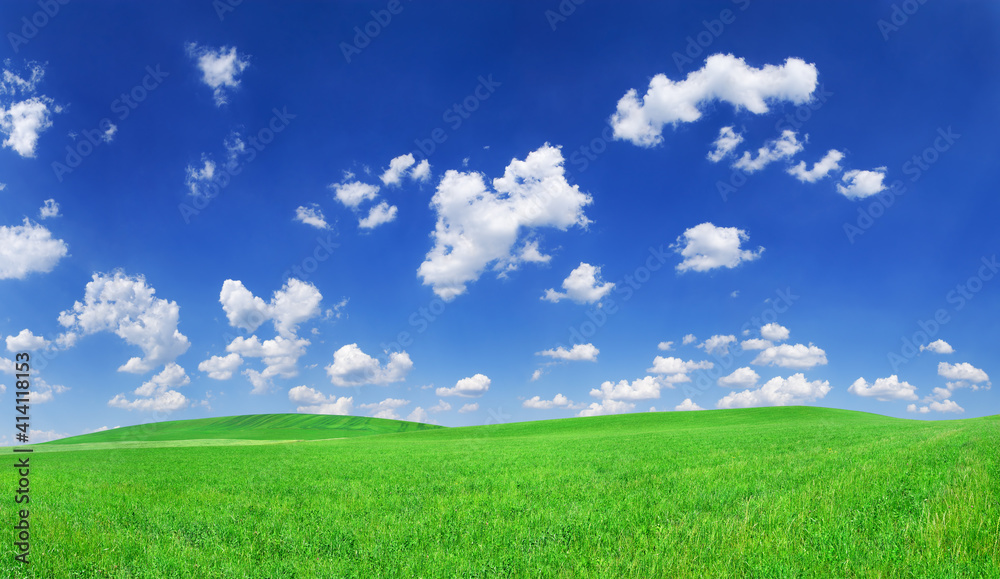 Idyllic view, green hills and blue sky with white clouds Idyllic view, green hills and blue sky with white clouds