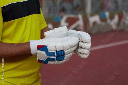 cricket player with white gloves
