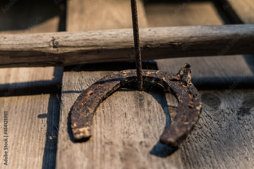 Rusty horseshoe hanging on the wall.Grandfather's inheritance. Rusty horseshoe hanging on the wall.Grandfather's inheritance.