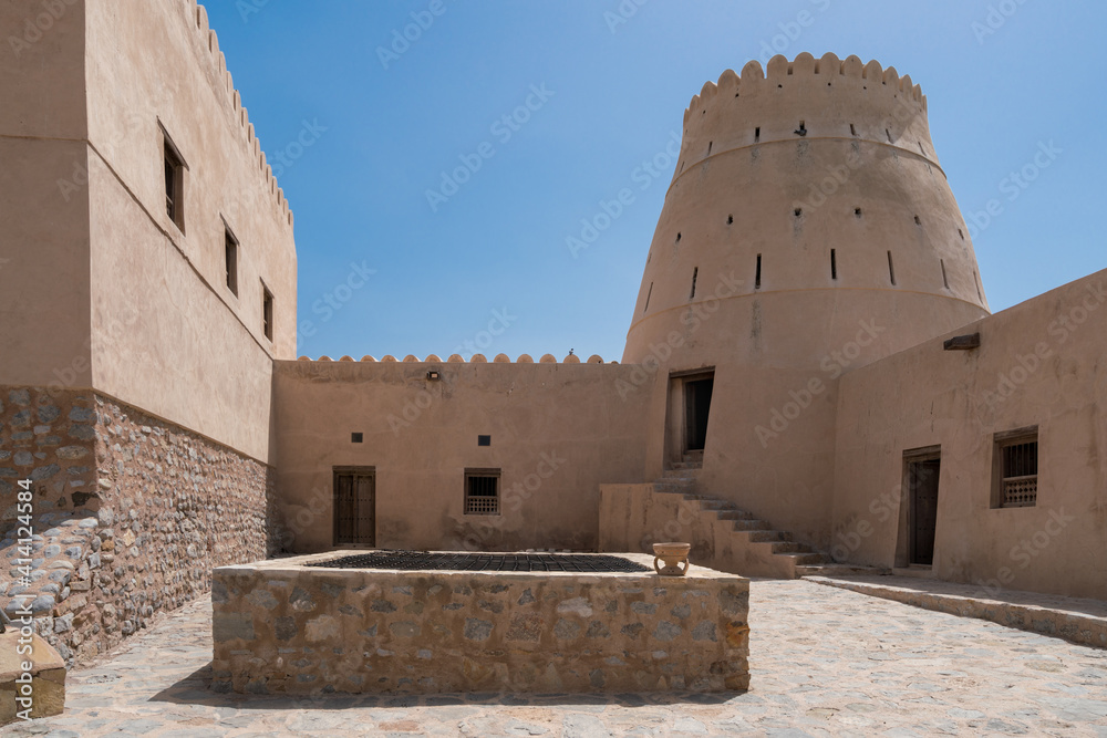 Courtyard of a small medieval arabian fort in Bukha, Oman. Windows, doors and round tower.