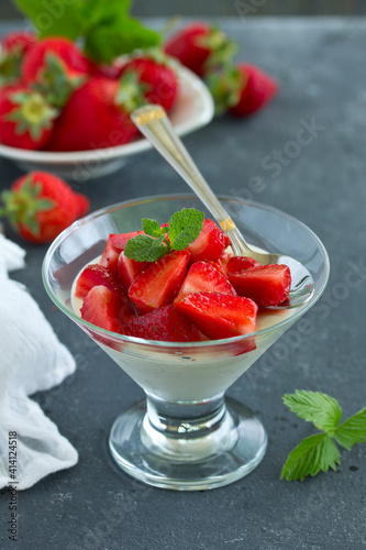Panna cotta with strawberry sauce and mint.